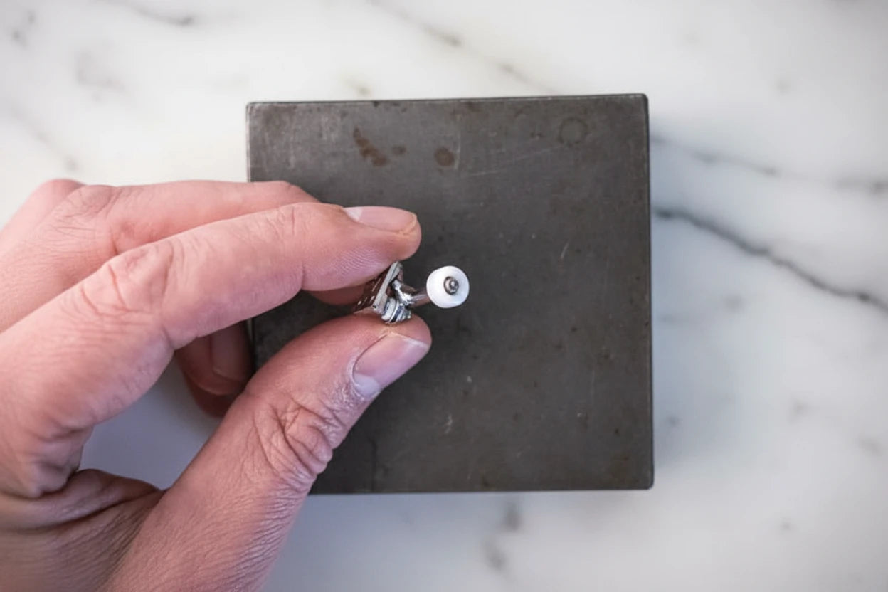 White ABS fingerboard wheels on truck with bearings. Marble background